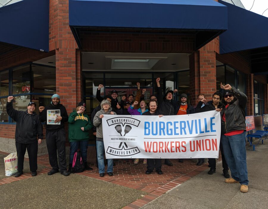 Burgerville Workers Union members holding a banner posing for a group photo