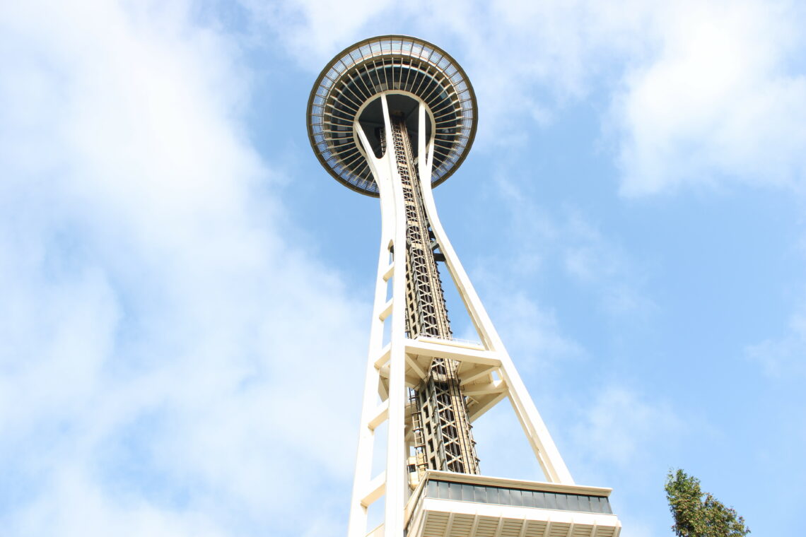 The Space Needle hovers over a Seattle blue sky. Porco Rossellini 2023.