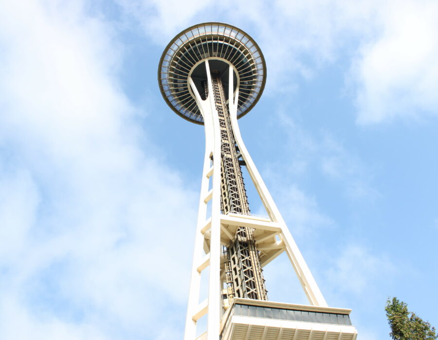 The Space Needle hovers over a Seattle blue sky. Porco Rossellini 2023.