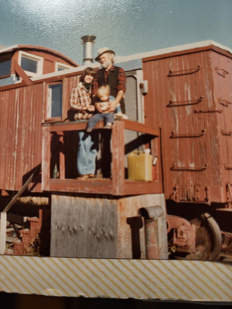 Utah Phillips, his wife, and one of his sons standing on the front "porch" of the flanger. Brendan Phillips