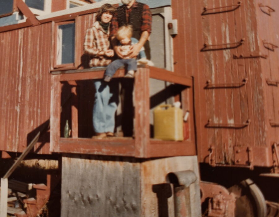 Utah Phillips, his wife, and one of his sons standing on the front "porch" of the flanger. Brendan Phillips
