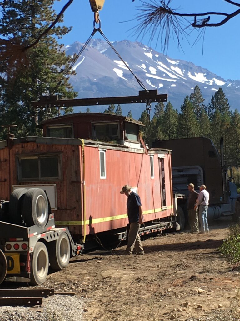 A crane lifts the flanger off a truck. Brendan Phillips