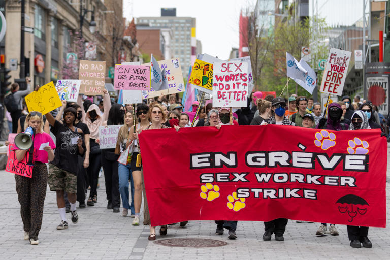 Courtesy of Evan Buhler, Montreal Gazette. Workers march on May 23 along Ste-Catherine St as part of the sex worker strike.